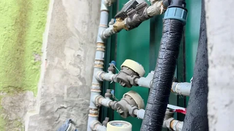 Exposed Water Meter and Utility Pipes on Residential Building Stock Footage 340382855