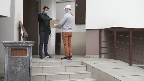 An express courier brought the parcel to the client's house. Coronavirus. Stock Footage 138922958