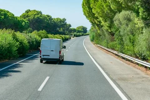 Express parcel delivery van driving on the highway Stock Photos