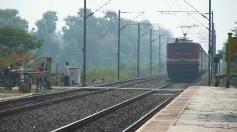 Express passenger train passes through station in India Stock Footage 21253780