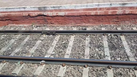 Express passenger train is passing though a railway station Видео 96274140