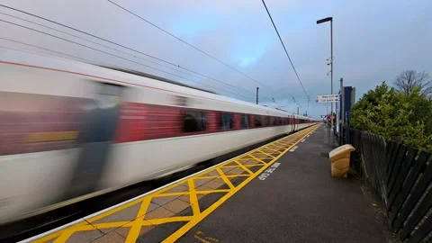 Express train do not slow down while passing train station. Stock Footage 234420103