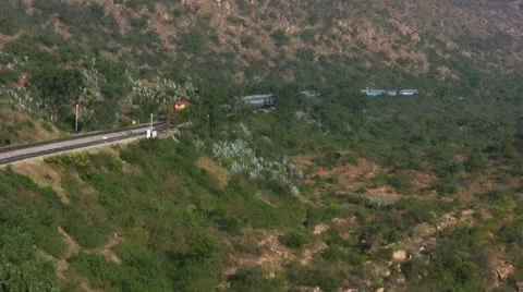 An Express train speeds through Makalidurga station near Bangalore India. Stock Footage 20845052