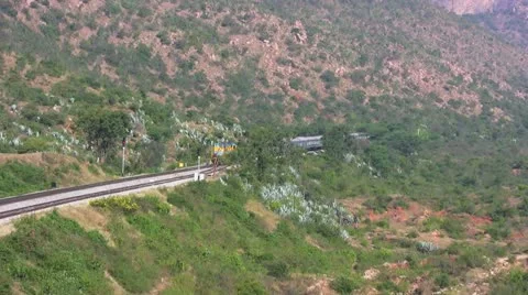 An Express train speeds through Makalidurga station near Bangalore India. Stock Footage 21238755