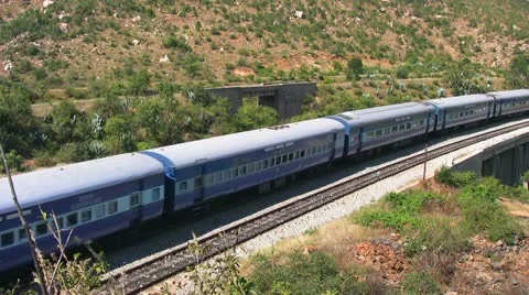 An Express train speeds through Makalidurga station near Bangalore India. Stock Footage 21239701