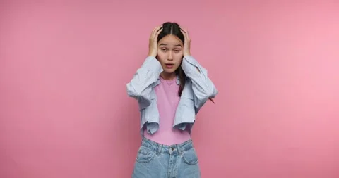 Expressing emotions in four frames with a young woman against a pink backgrou Stock Footage 317327668