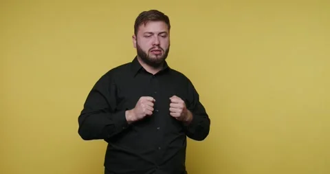 Expressing emotions through gestures in a bright yellow setting with vivid .. Video stock 329110878