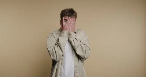 Expressing emotions through hands covering the face in a creative space wit.. Video stock 329113077