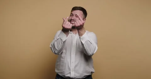 Expressing love through gestures in a vibrant yellow setting with a lively .. Видео 329110204