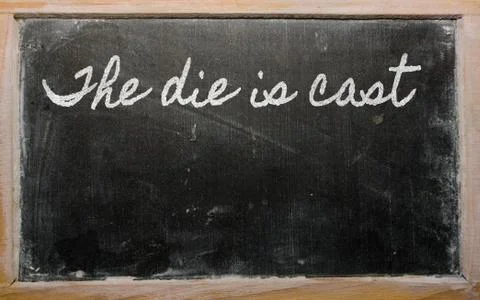 Expression -  the die is cast - written on a school blackboard with chalk Stock Illustration