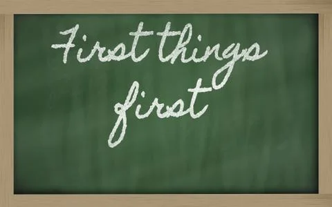 Expression - first things first  - written on a school blackboard with chalk Stock Illustration