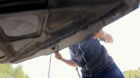 Expression Furious Driver driver is trying to fix the engine Stock Footage 75707959