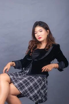 Expression girl formal thin smile hands to the seats all Foto stock