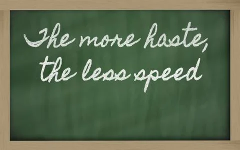 Expression -  the more haste, the less speed - written on a school blackboard Stock Photos