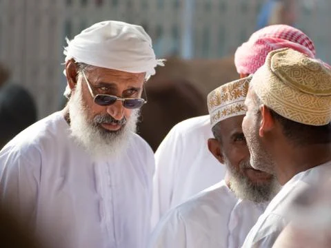 An expression of an Omani man who discusses with other men at the Friday mark Stock Photos