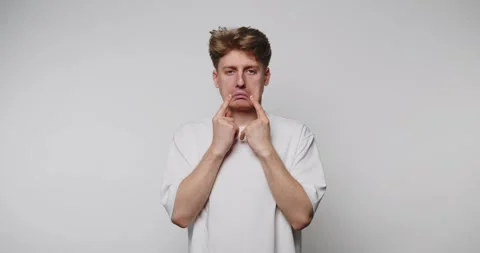 Expression of sadness captured indoors by a young man in casual clothing sh.. Stock Footage 316180836