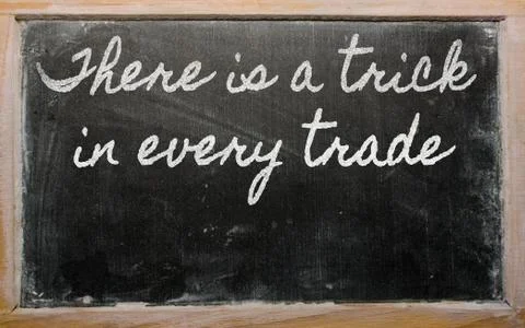 Expression -  there is a trick in every trade - written on a school blackboar Stock Photos