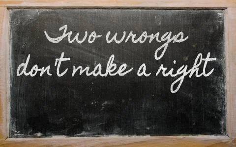 Expression -  two wrongs don't make a right - written on a school blackboard  Stock Photos
