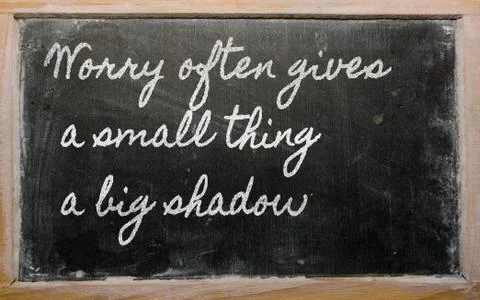 Expression -  worry often gives a small thing a big shadow - written on a sch Stock Photos