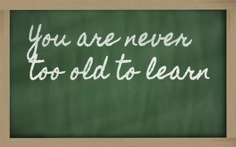 Expression -  you are never too old to learn - written on a school blackboard Stock Photos