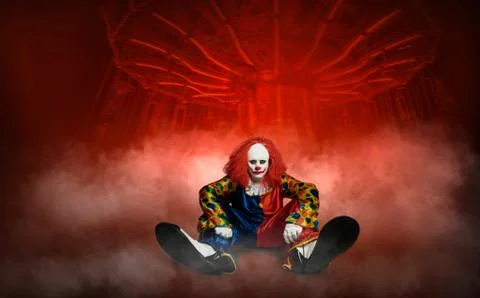 Expressionless clown against the abstract background of an amusement park Stock Photos