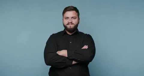 Expressions of reflection with a focused man in a vibrant blue background 動画素材 329111039