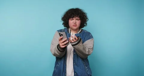 Expressions of youth in a simple setting while a person uses a phone with v.. Stock Footage 328247764