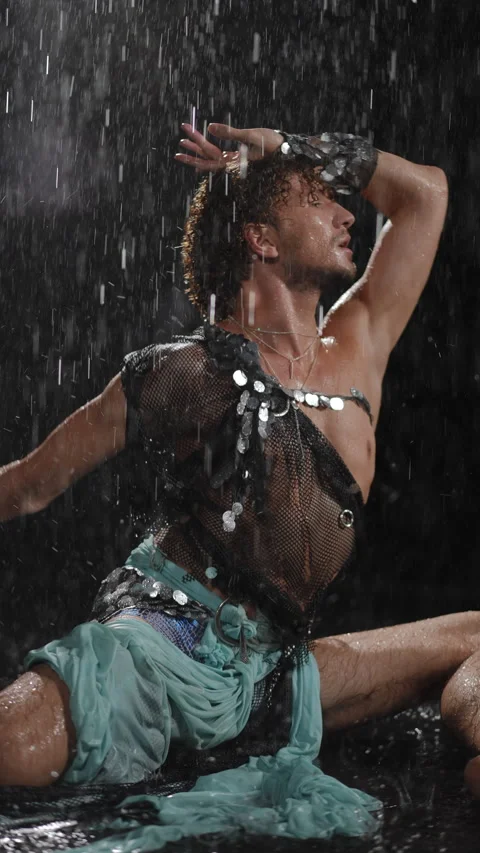 An Expressive and Dramatic Pose Captured on a Rainy Night with Artistic Flair Stock Footage 313423842