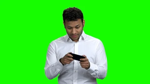 Expressive businessman playing game on mobile phone. Stock Footage 114708539