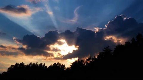 Expressive clouds in the setting sun over the forest Stock Footage 143992946