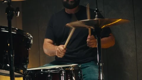 Expressive drummer young man professionally playing on dums in studio room close Stock-Footage 258374402