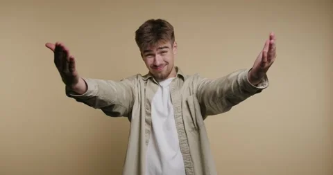 Expressive gestures of a young man conveying joy and excitement in playful .. Видео 329113124