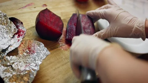 Expressive gloved hands mixing vivid beet purée into flour in hero view, 4K Stock Footage 341111386