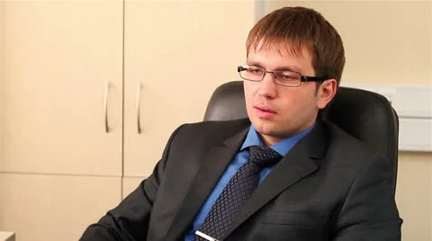 Expressive good looking r man at the office workplace. Cleaning his glasses. Stock Footage 24857826