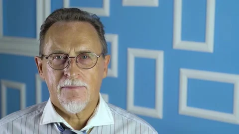 Expressive good looking senior man against bright wall. Stock Footage 134924701