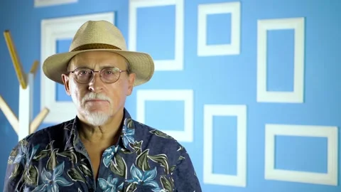 Expressive good looking senior man against bright wall. Stock Footage 134931556