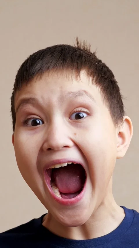 Expressive little boy making funny faces, screaming with mouth wide open, and 库存影片 342903929