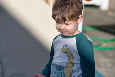 Expressive little boy playing in the backyard and making faces Stock Photos