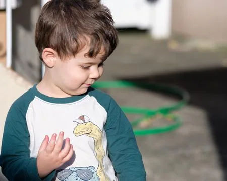 Expressive little boy playing in the backyard and making faces Stock-Fotos