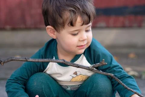Expressive little boy playing in the backyard and making faces Stock Photos