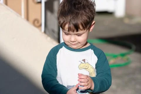 Expressive little boy playing in the backyard and making faces 写真素材