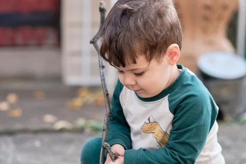 Expressive little boy playing in the backyard and making faces Stock Photos