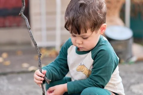 Expressive little boy playing in the backyard and making faces Stock Photos