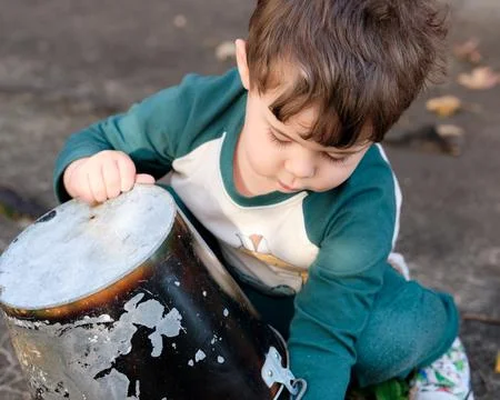 Expressive little boy playing in the backyard and making faces Foto stock
