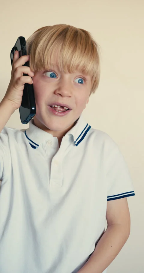 Expressive little boy talking on smartphone Video stock 346983301