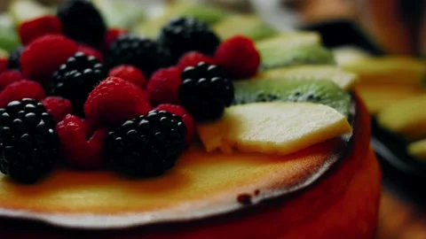 Expressive low angle across berries and green kiwi slices in low angle, 4K Stock Footage 341116109