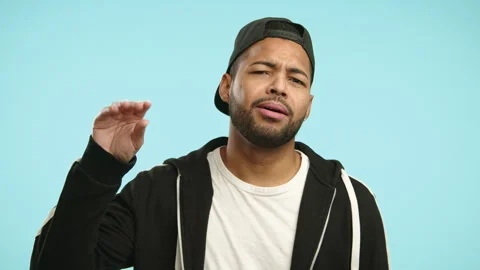 Expressive Man Indicates Too Much Gossip with a Hand Gesture Stock Footage 276416316