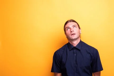 Expressive man looking up contemplative Stock Photos