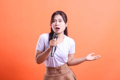 Expressive Singer on Orange Background Stock Photos
