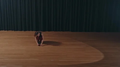Expressive solo stage dance in spotlight center Stock Footage 309292474